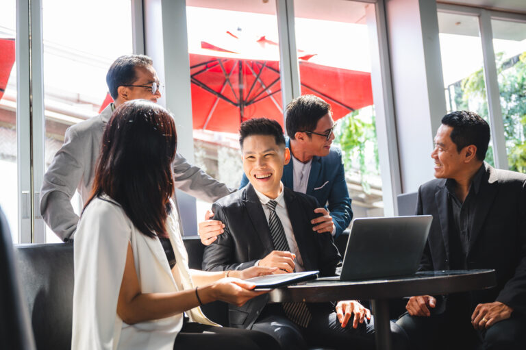 Business professionals discussing strategies to promote Malaysian-made products and services in international markets, emphasizing export growth and global reach