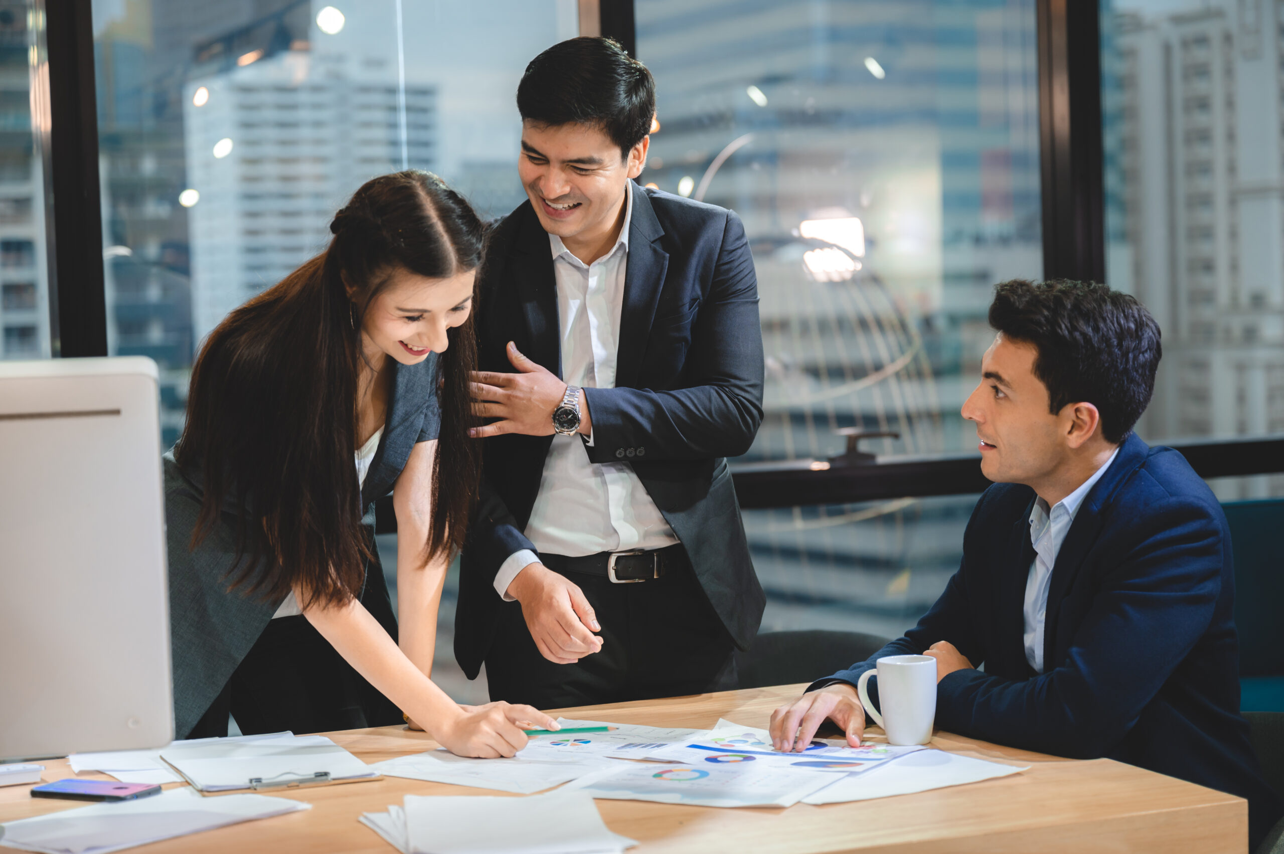 Financial experts in Malaysia consulting with a client on the details of a grant application, offering guidance and insights