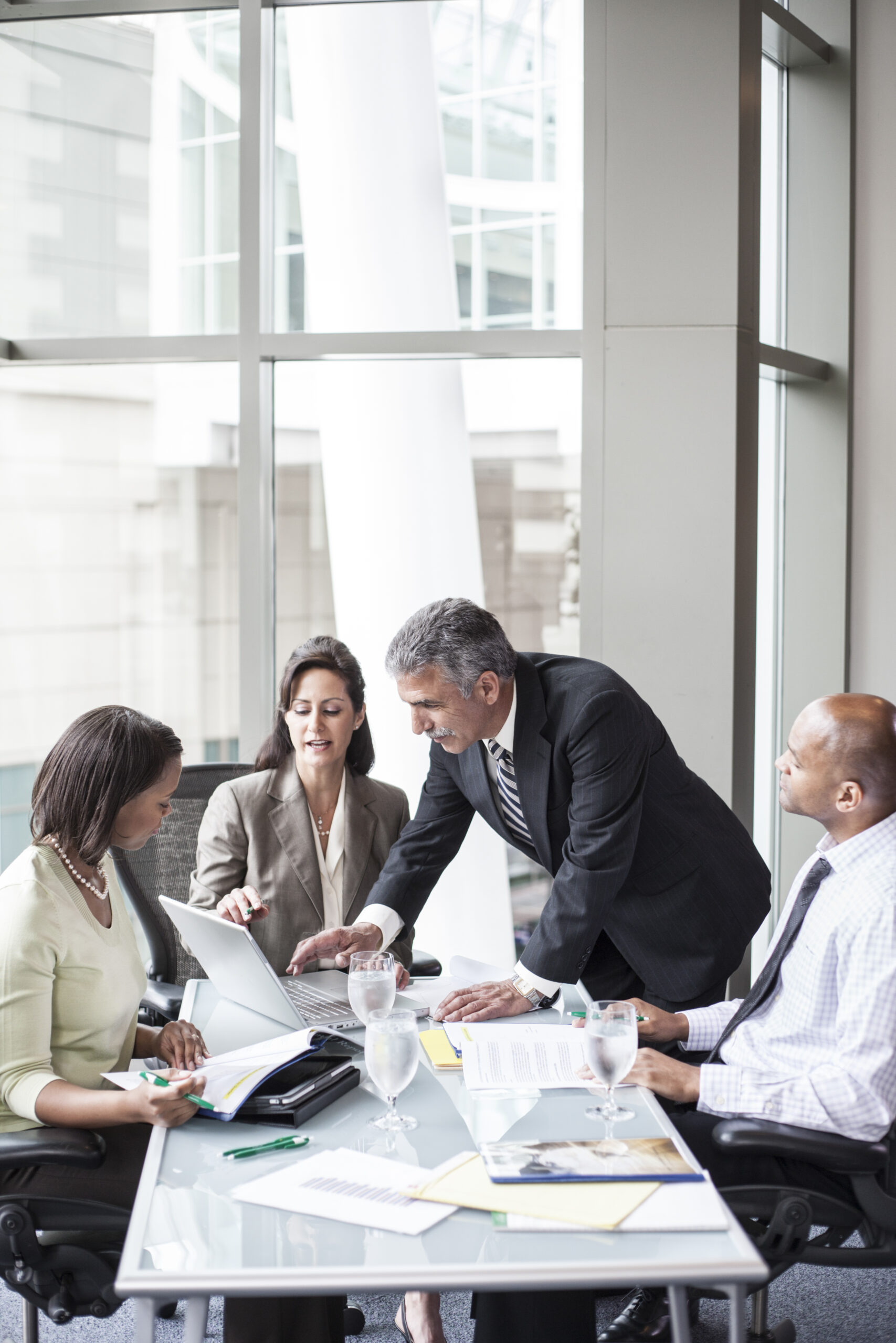Group of consultants analyzing grant application strategies in Malaysia